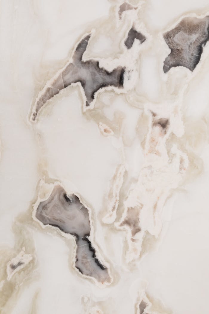 High-resolution marble texture showing intricate natural patterns and soft colors, ideal for backgrounds or design work.